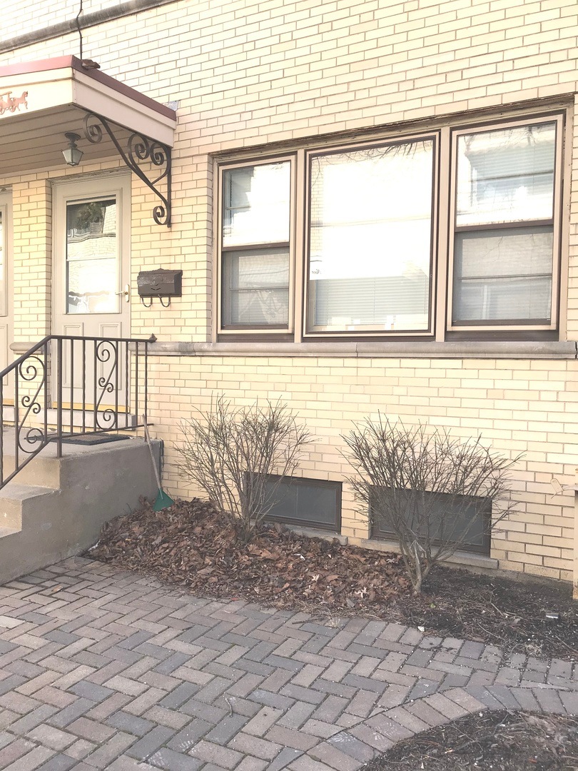 End unit brick townhouse with a brick patio