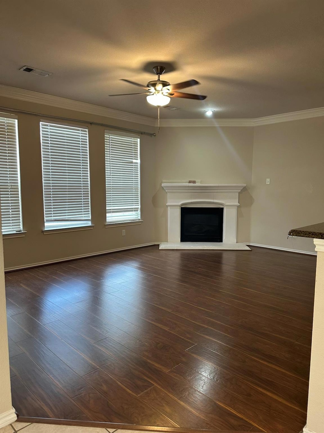 Unfurnished living room featuring ornamental moldi