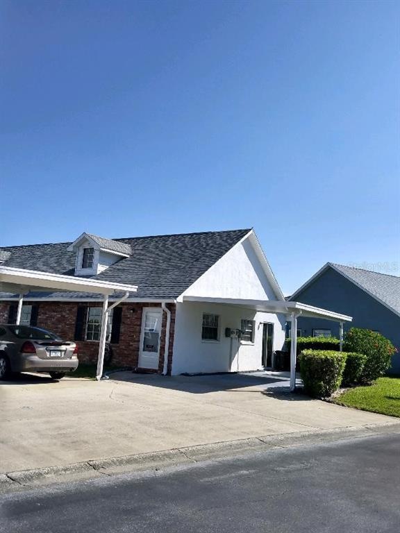 End unit with covered carport and additional drive