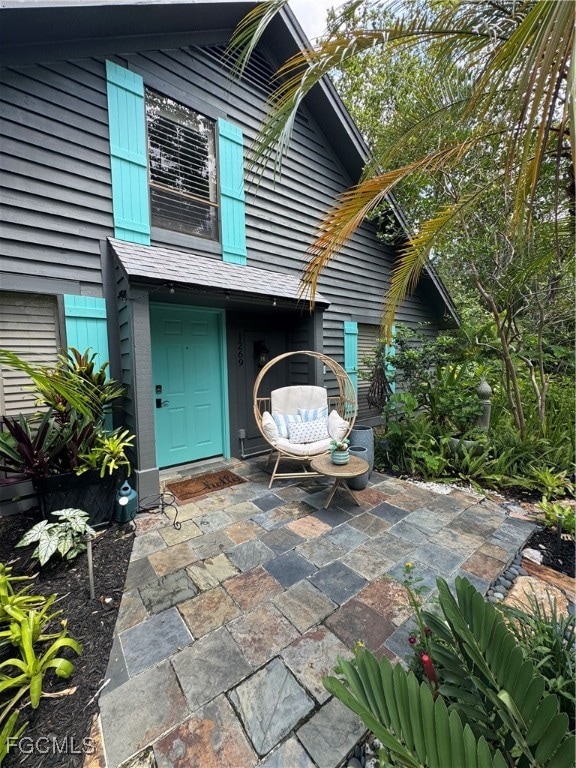 Doorway to property featuring a patio area