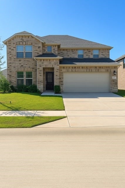 View of front facade featuring driveway, a front yard, and brick siding