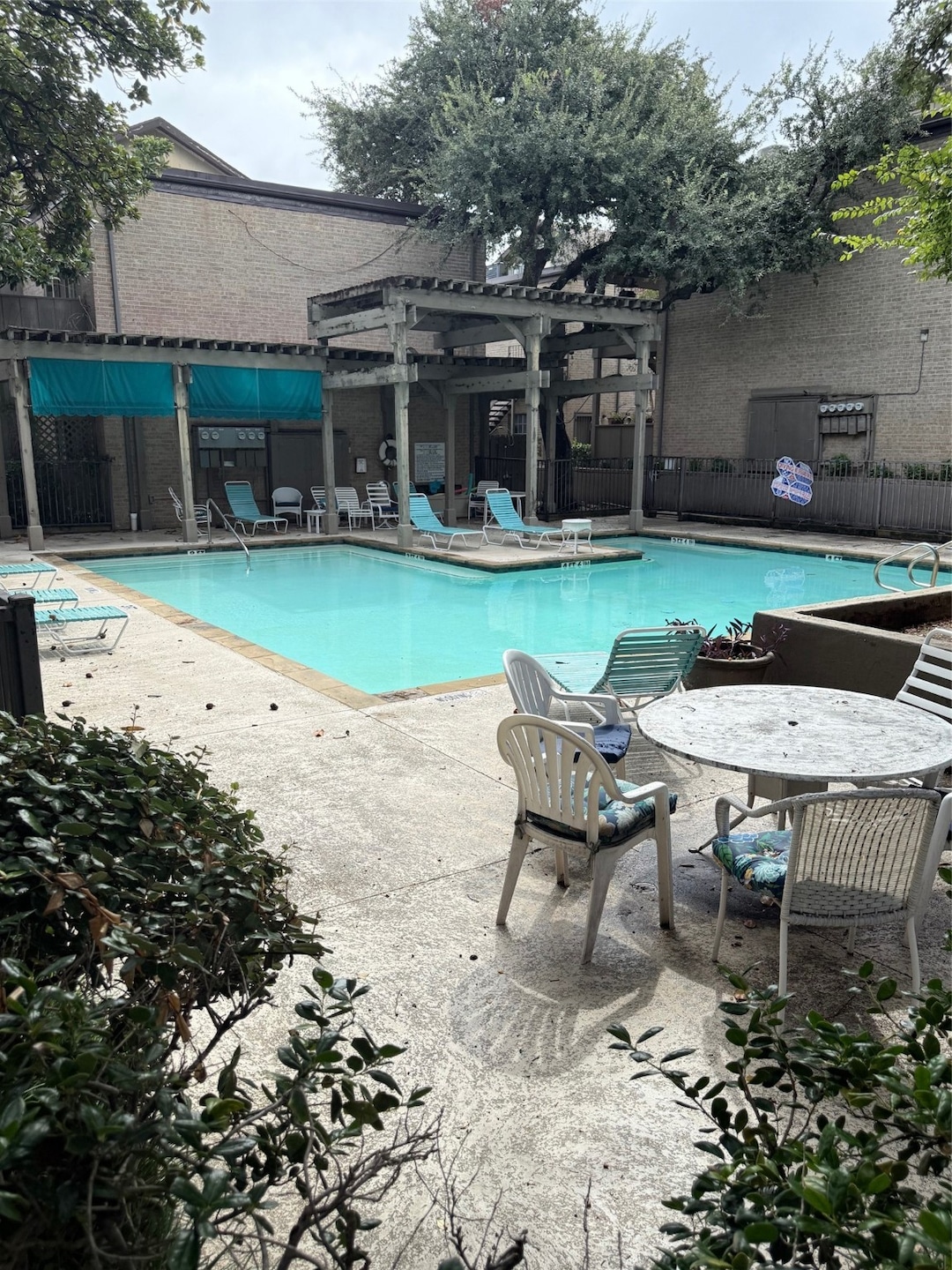 Community pool featuring a patio area and a pergola