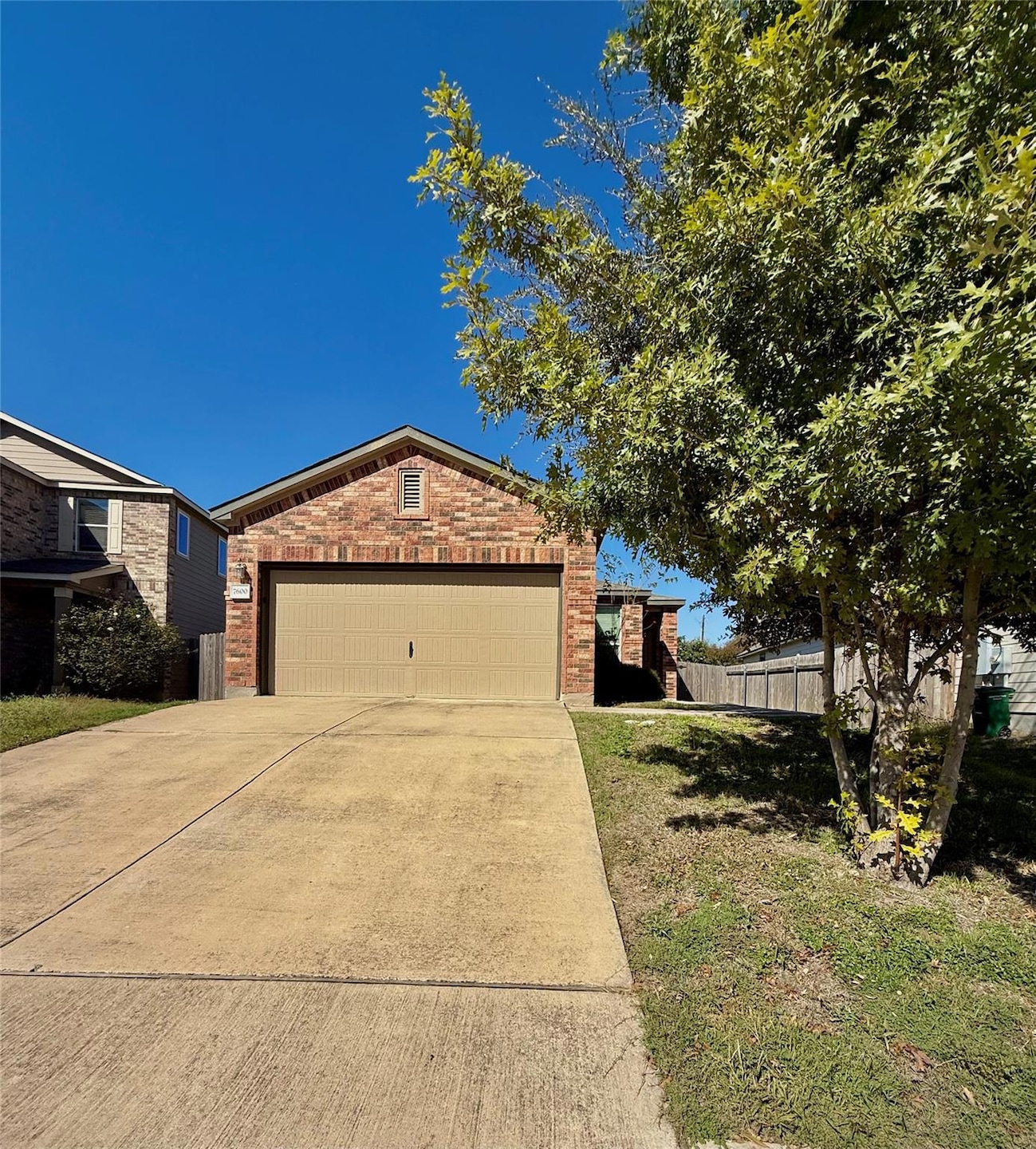 View of front facade with brick siding and concrete driveway