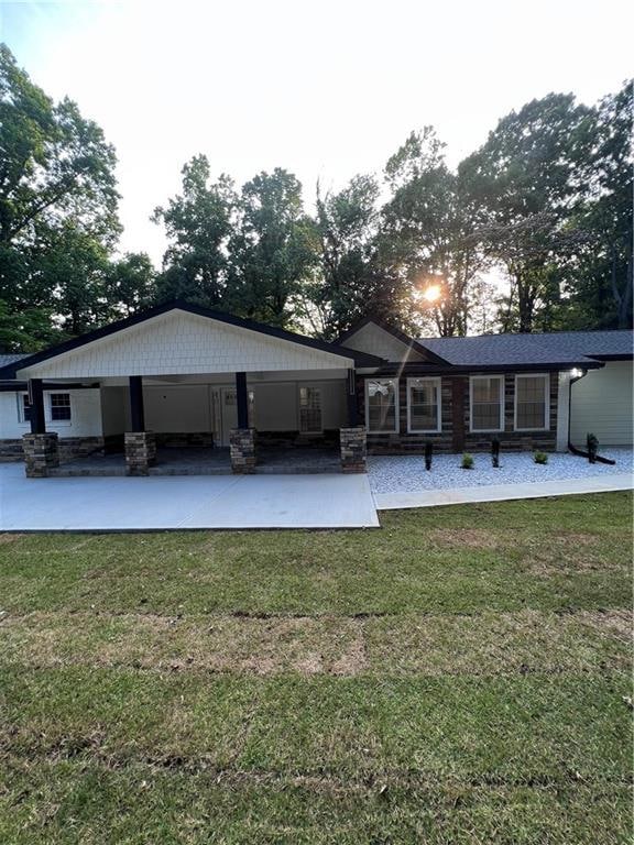 Rear view of house with a yard