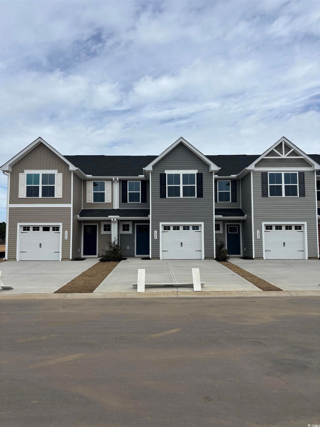 View of front facade featuring concrete driveway a