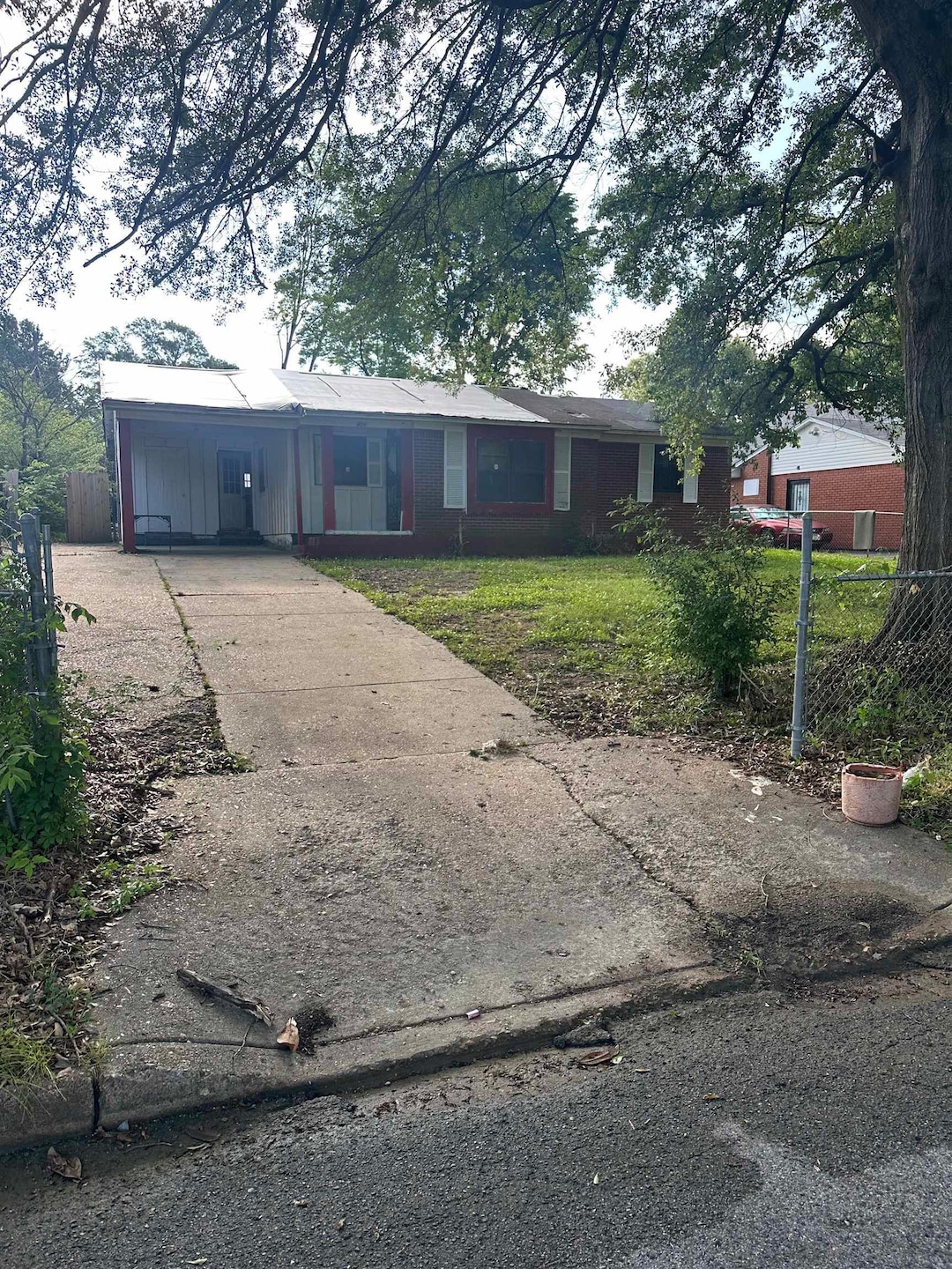 Ranch-style home featuring concrete driveway and a