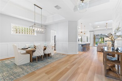 Dining area with crown molding, a tray ceiling, a