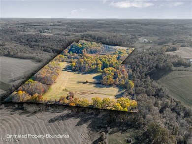 Aerial view of a heavily wooded area and crop land
