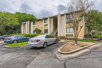 View of property featuring uncovered parking