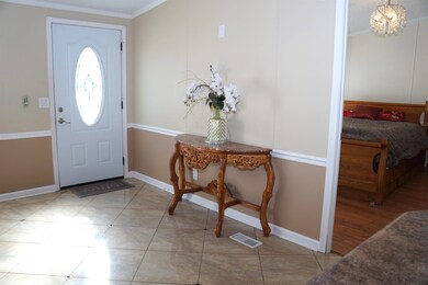 Entrance foyer with baseboards, light tile pattern