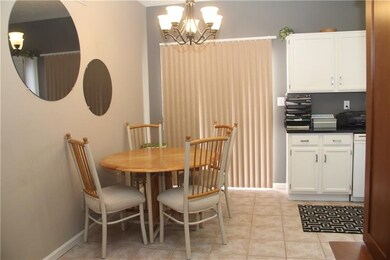 Dining area of kitchen with sliding glass doors opening up to covered patio