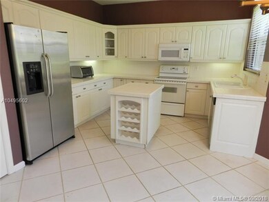 Large kitchen with under cabinet lighting and isla