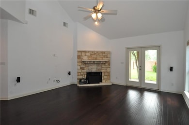 Unfurnished living room featuring high vaulted ce