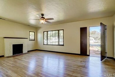 Spacious living room with refinished hardwood floo