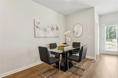 Dining space featuring dark wood-type flooring and baseboards