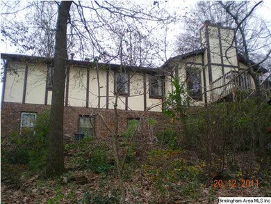 Back of house taken from the woodsy backyard.  At 