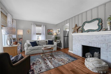 Living room with wood burning fireplace.