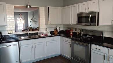 Brick accent theme continues in kitchen area. Popu