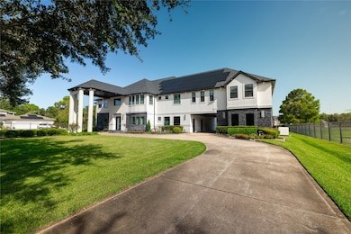 The photo showcases a large, two-story modern home