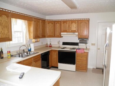 Kitchen features oak cabinetry and plenty of counter space.