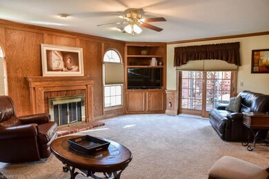 Family room with a fireplace and built-in bookshel