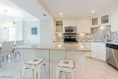 Kitchen with stainless steel appliances, a sink, d
