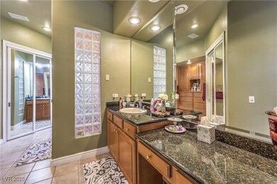 Bathroom with tile patterned flooring, vanity, bas