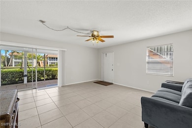 Living room with light tile patterned floors, a te