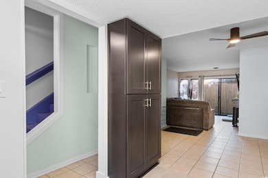 Corridor featuring light tile patterned floors and