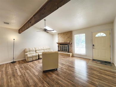 Living area with a fireplace, wood finished floor