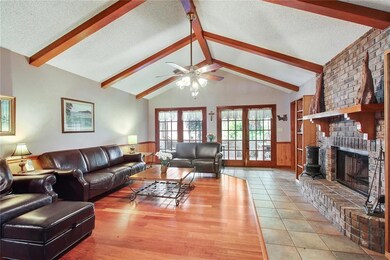 Living room has vaulted ceilings, wood and tile fl