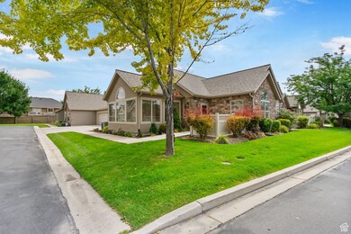 View of front of home with concrete driveway, stone siding, a sunroom, an attached garage, and a shingled roof