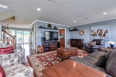The Living Room has rich wall color accented by pr