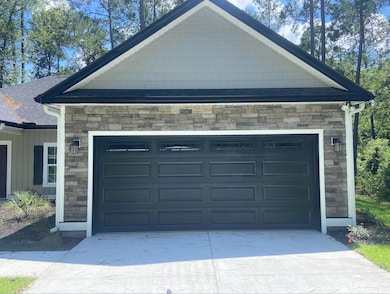 Garage featuring driveway
