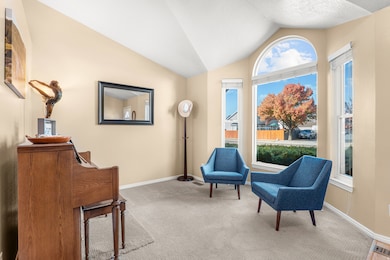 Living area featuring lofted ceiling and carpet