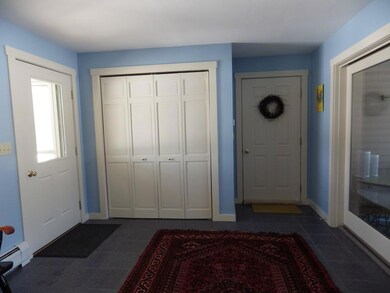 Mud room with tile floors with...