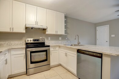 Kitchen equipped with stainless dishwasher and coo