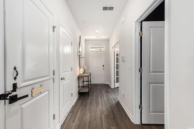 Corridor featuring dark wood finished floors and recessed lighting