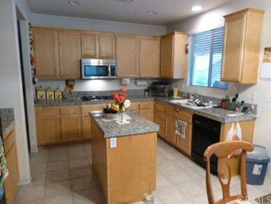 Kitchen with granite counter top and island