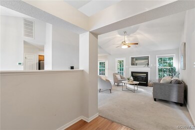 living room featuring a fireplace and ceiling fan