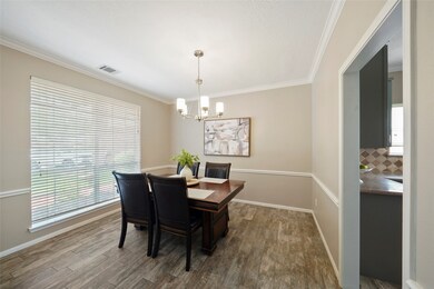 Dining room with crown molding, chair railing, and updated light fixtures. Home has been well-maintained!