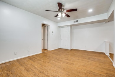 Empty room featuring baseboards, visible vents, ce