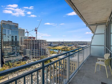 Balcony featuring a water view and a view of city