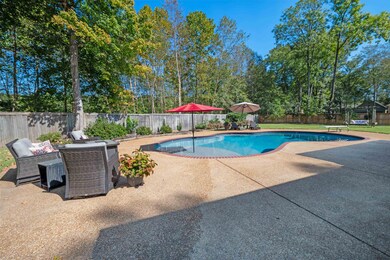 View of swimming pool featuring a patio and a divi