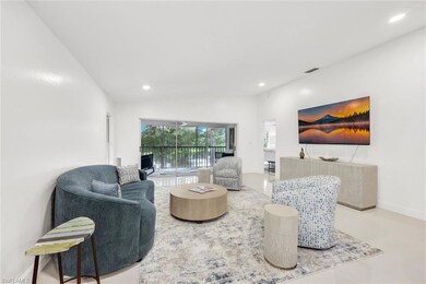 Living room featuring view of lake, vaulted ceilin