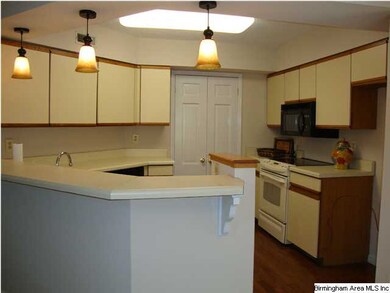 Kithen with breakfast bar opens to the dining room