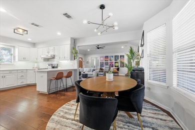 Dining room with ceiling fan, dark wood-style flooring, a chandelier, and recessed lighting