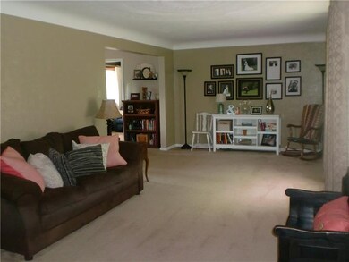 This Living Room is 25x11, has a very large front window and a beautifully plastered ceiling.  There is hardwood under the carpeting.