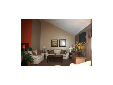 LIVING ROOM WITH VAULTED CEILINGS AND SKYLIGHT