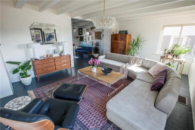 Dreamy living area, bathed in natural light, flows perfectly into the cozy dining space.